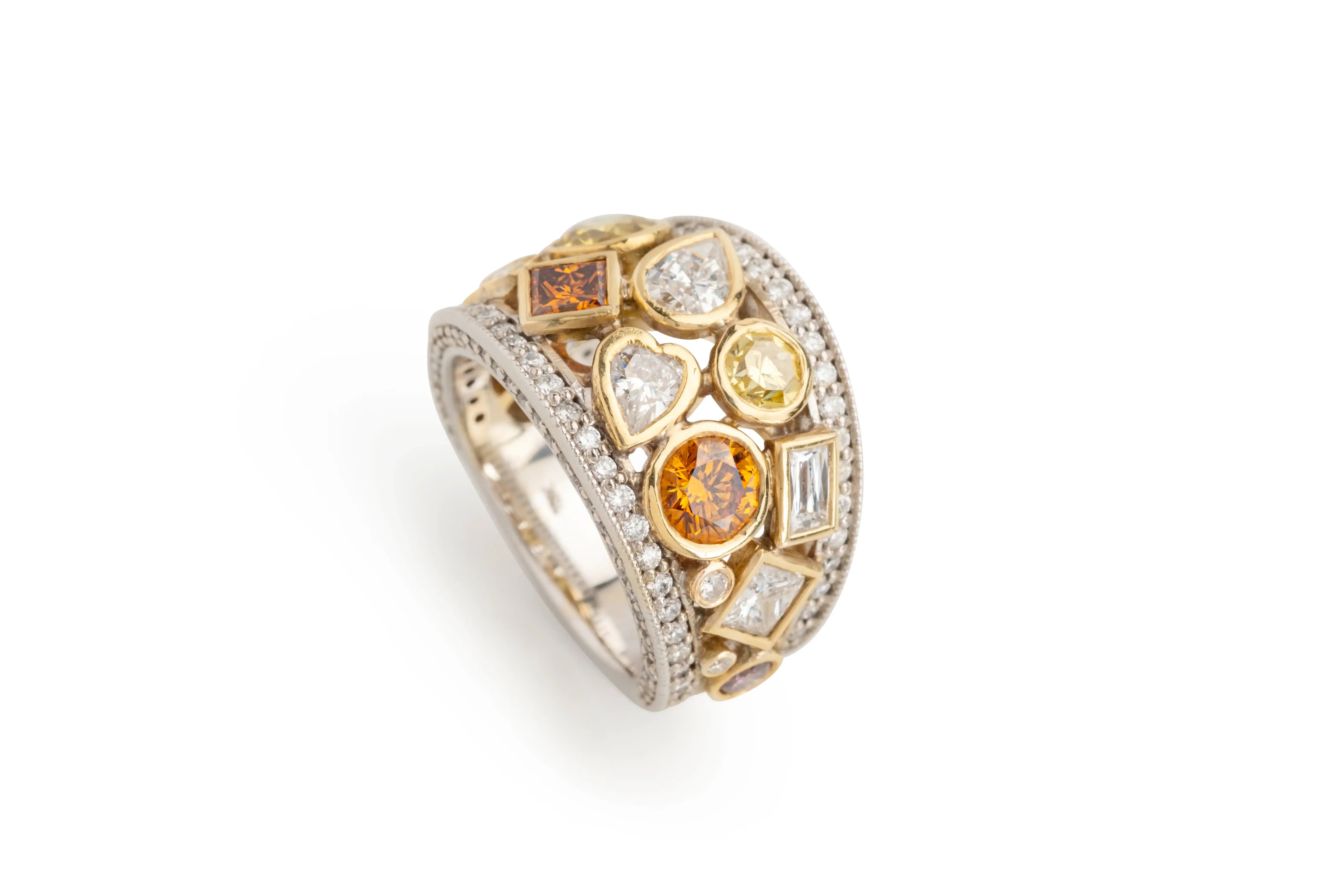 Wide gold and silver ring with assorted colorful gemstones and diamonds on white background