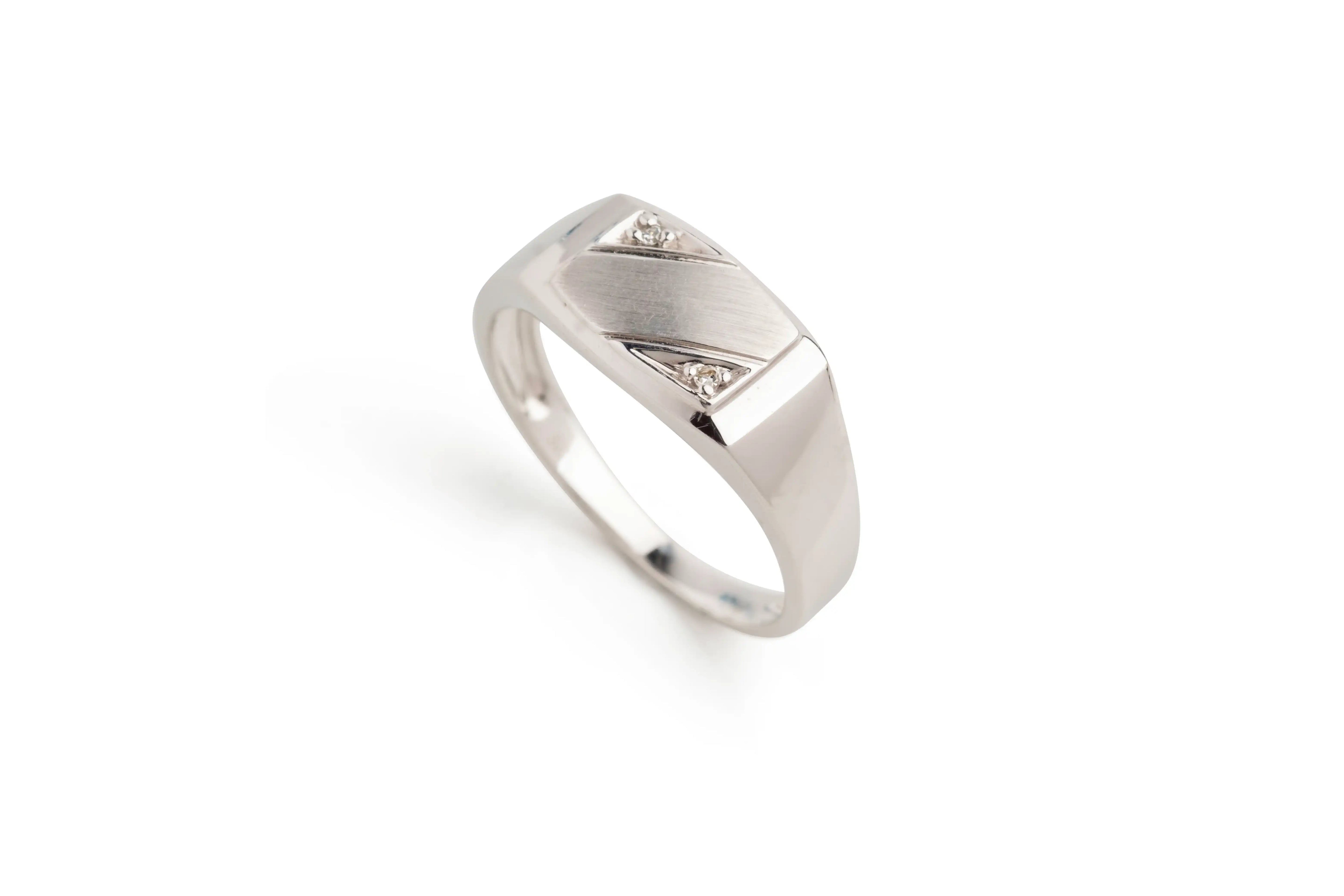 Silver men's ring with brushed rectangular top and two small round diamonds on white background